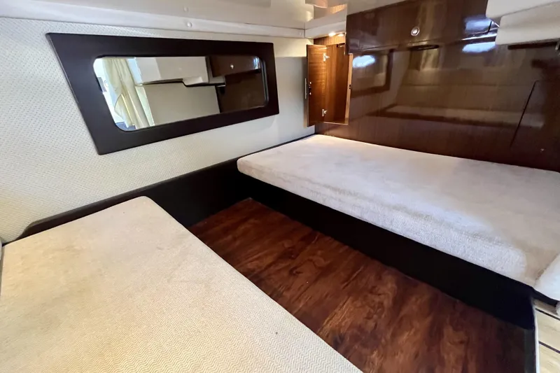  Yacht Photos Pics Interior cabin of 2013 Regal 35 Sport Coupe with twin beds and wooden accents.