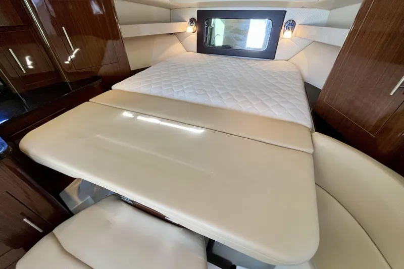  Yacht Photos Pics Luxurious interior of 2013 Regal 35 Sport Coupe with cozy bed and elegant wood finishes.