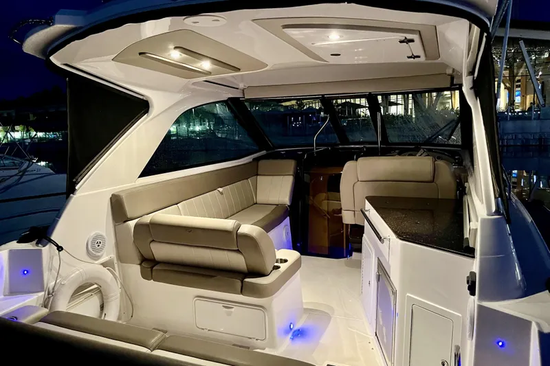  Yacht Photos Pics Luxurious interior of 2013 Regal 35 Sport Coupe yacht at night, featuring elegant seating and lighting.