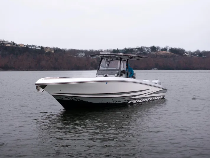  Yacht Photos Pics 2022 Fountain 38 SC boat on calm water, overcast sky, distant shoreline.
