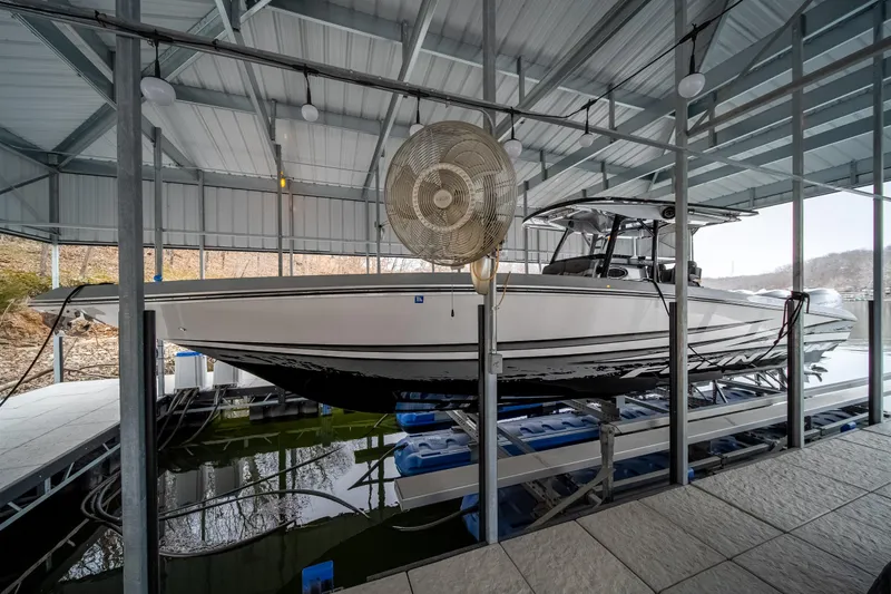  Yacht Photos Pics 2022 Fountain 38 SC boat docked in covered marina.