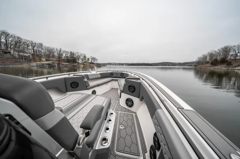  Yacht Photos Pics 2022 Fountain 38 SC boat interior on calm lake with overcast sky.