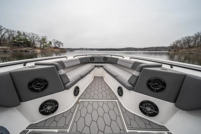  Yacht Photos Pics 2022 Fountain 38 SC boat interior with gray seating and speakers on a calm lake.