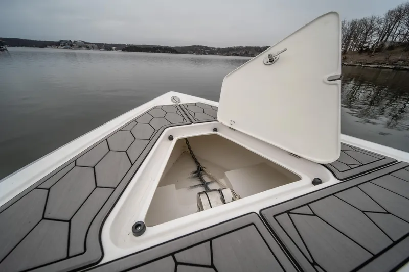  Yacht Photos Pics 2022 Fountain 38 SC boat with open storage compartment on calm lake.