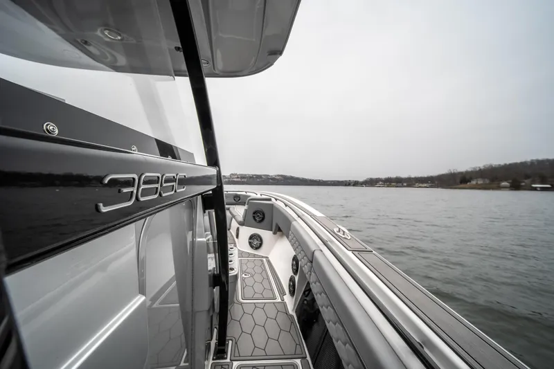  Yacht Photos Pics 2022 Fountain 38 SC boat on a calm lake, showcasing sleek design and modern features.