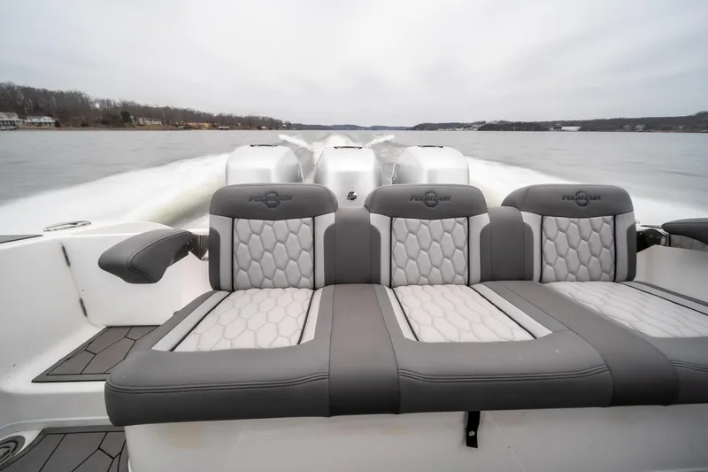  Yacht Photos Pics 2022 Fountain 38 SC boat with luxurious seating on a calm lake.