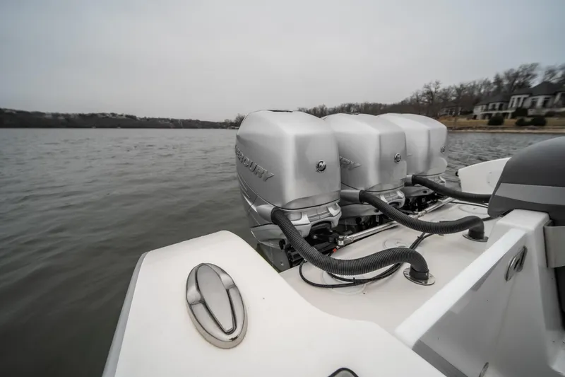  Yacht Photos Pics 2022 Fountain 38 SC boat with triple outboard engines on a lake.