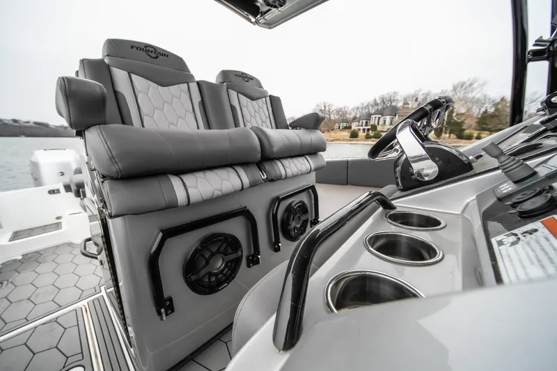  Yacht Photos Pics 2022 Fountain 38 SC boat interior with luxury seating and modern dashboard.