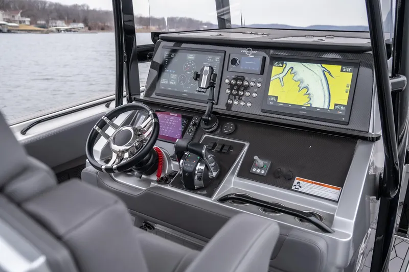  Yacht Photos Pics Control panel of 2022 Fountain 38 SC boat with navigation screens and steering wheel.