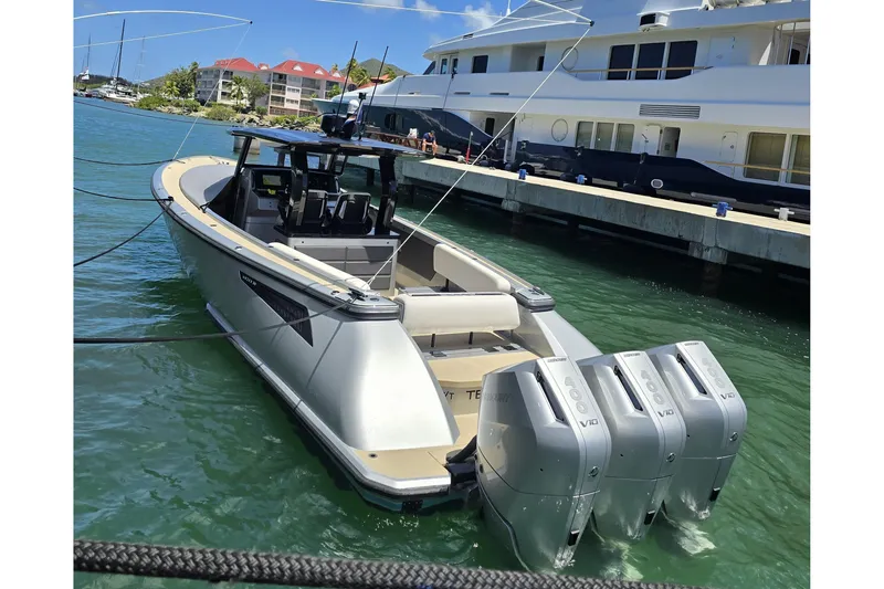 T/t Tenacious Yacht Photos Pics 2025 Wajer 38s luxury boat docked, featuring triple outboard engines, in a marina setting.