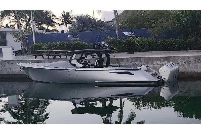 T/t Tenacious Yacht Photos Pics 2025 Wajer 38s luxury boat docked at IGY Marina, reflecting on calm water.