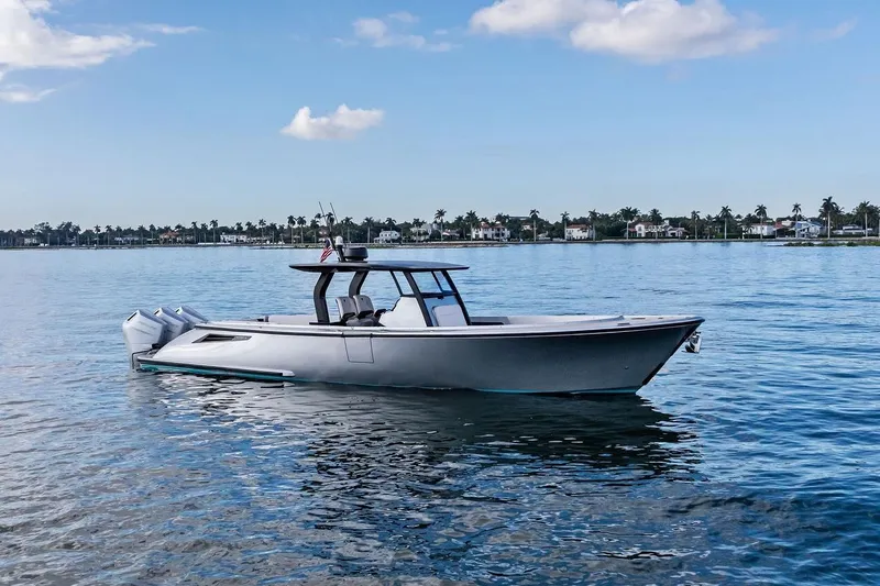 T/t Tenacious Yacht Photos Pics 2025 Wajer 38s boat on calm water, clear sky, and distant shoreline.