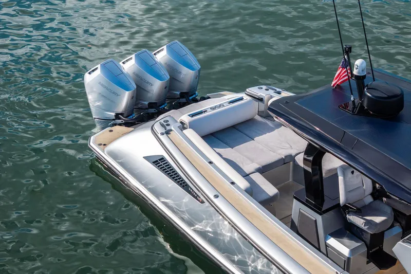 T/t Tenacious Yacht Photos Pics 2025 Wajer 38s luxury boat with triple outboard engines on calm water.