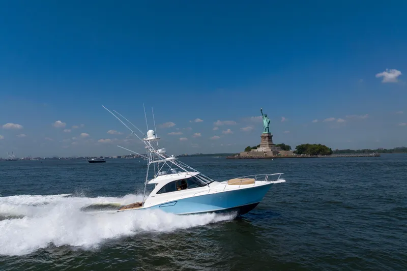  Yacht Photos Pics 2012 Cabo 44 Hardtop Express yacht cruising near Statue of Liberty.