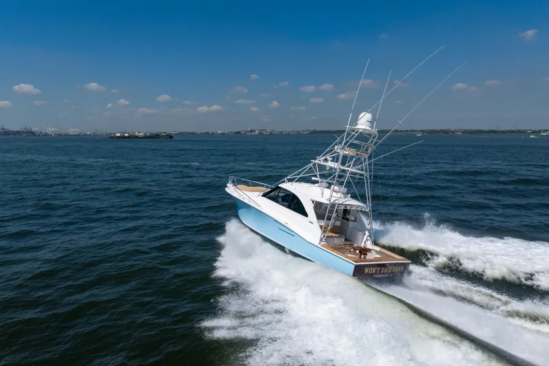  Yacht Photos Pics 2012 Cabo 44 Hardtop Express yacht cruising on open water under clear skies.