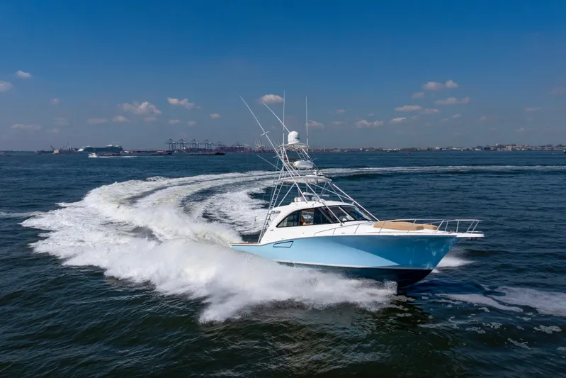  Yacht Photos Pics 2012 Cabo 44 Hardtop Express yacht cruising on open water under clear skies.