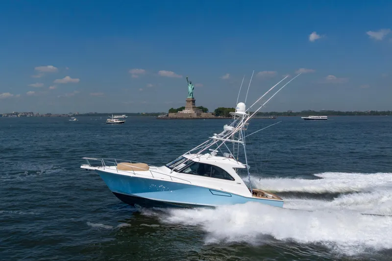  Yacht Photos Pics 2012 Cabo 44 Hardtop Express yacht cruising near the Statue of Liberty.