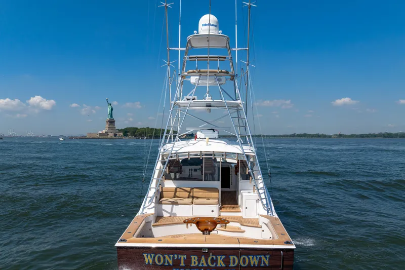  Yacht Photos Pics Cabo 44 Hardtop Express 2012 yacht near Statue of Liberty on a sunny day.
