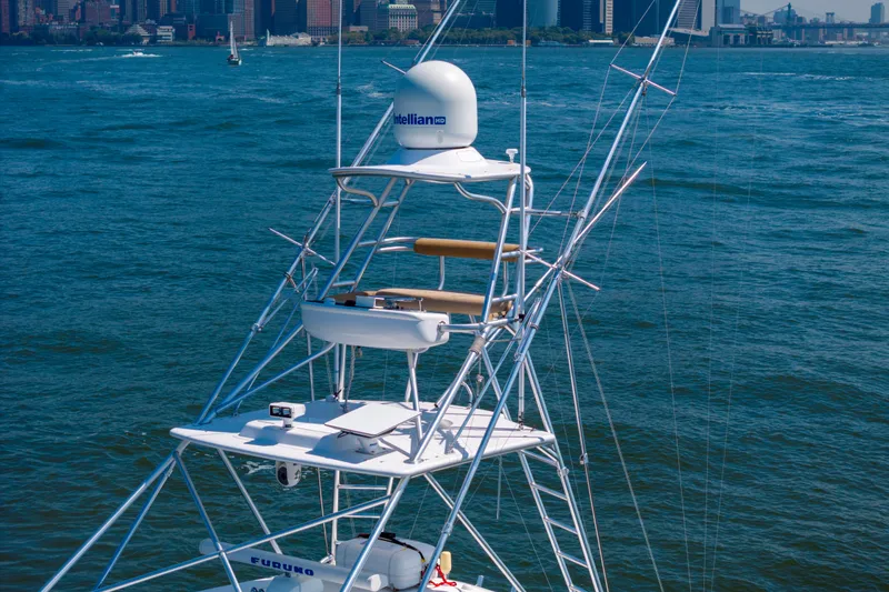  Yacht Photos Pics 2012 Cabo 44 Hardtop Express yacht tower with city skyline in background.