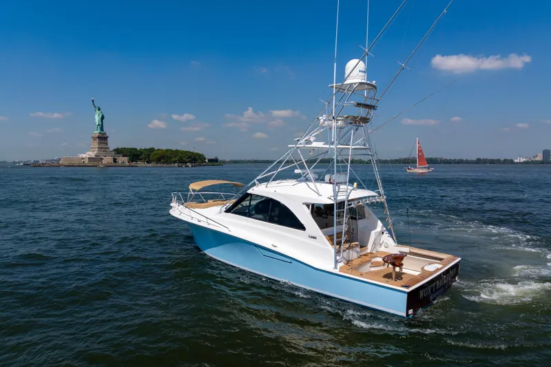  Yacht Photos Pics 2012 Cabo 44 Hardtop Express yacht near Statue of Liberty on sunny day.
