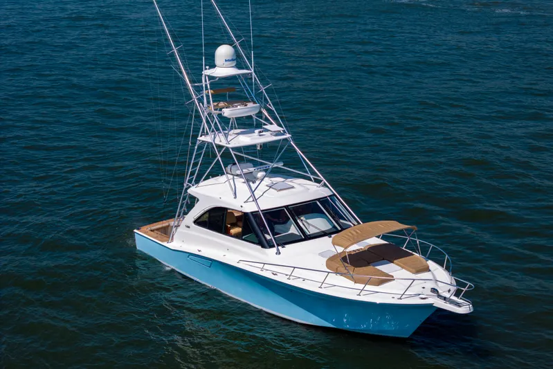  Yacht Photos Pics 2012 Cabo 44 Hardtop Express yacht on open water, featuring a sleek design and tower.