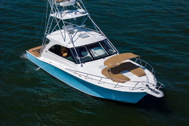  Yacht Photos Pics 2012 Cabo 44 Hardtop Express yacht cruising on open water.