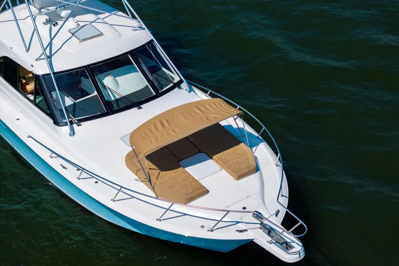  Yacht Photos Pics 2012 Cabo 44 Hardtop Express yacht with sunbathing area on calm water.