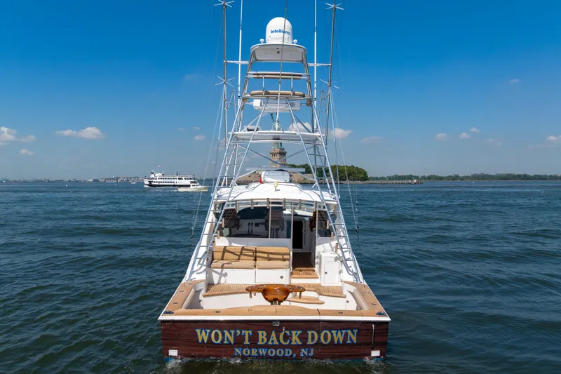  Yacht Photos Pics 2012 Cabo 44 Hardtop Express yacht on water, clear sky, rear view.