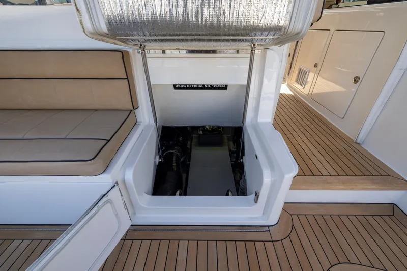  Yacht Photos Pics 2012 Cabo 44 Hardtop Express engine compartment with teak flooring and cushioned seating.