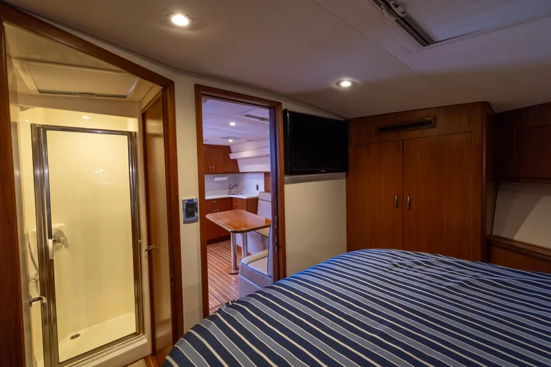  Yacht Photos Pics Luxurious interior of 2012 Cabo 44 Hardtop Express yacht with bedroom and kitchenette.