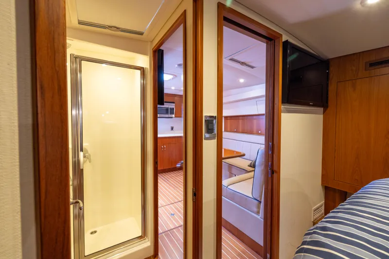  Yacht Photos Pics Interior of 2012 Cabo 44 Hardtop Express yacht with shower and dining area.