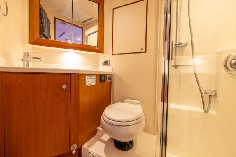  Yacht Photos Pics Luxurious bathroom in 2012 Cabo 44 Hardtop Express yacht with shower and wooden cabinetry.