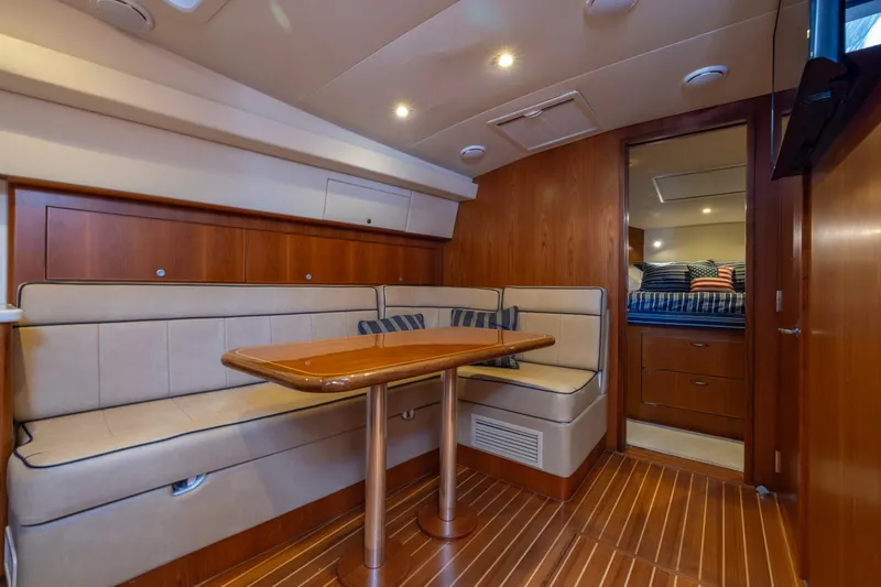  Yacht Photos Pics Luxurious interior of 2012 Cabo 44 Hardtop Express yacht with cozy seating and wooden finishes.