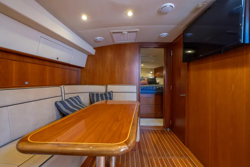  Yacht Photos Pics Luxurious interior of 2012 Cabo 44 Hardtop Express yacht with wood finishes and seating area.