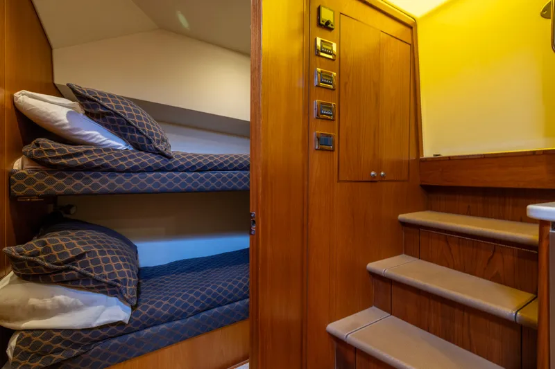  Yacht Photos Pics Interior of 2012 Cabo 44 Hardtop Express with bunk beds and wooden stairs.