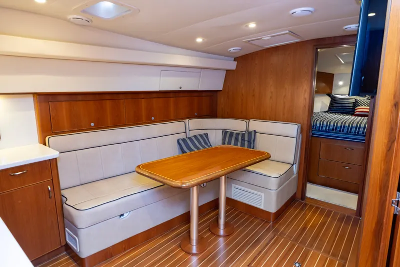  Yacht Photos Pics Luxurious interior of 2012 Cabo 44 Hardtop Express yacht with elegant wood finishes.