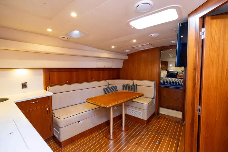  Yacht Photos Pics Luxurious interior of 2012 Cabo 44 Hardtop Express yacht with wood finishes and cozy seating.