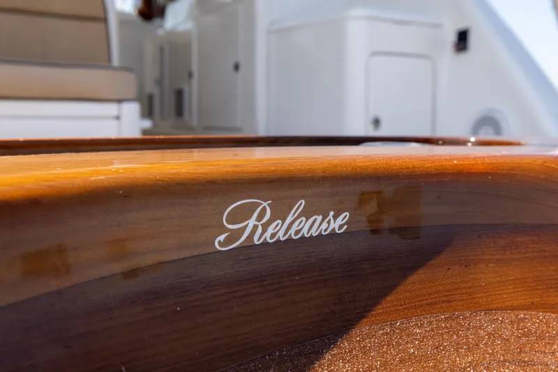  Yacht Photos Pics Wooden detail on 2012 Cabo 44 Hardtop Express boat, featuring "Release" text.