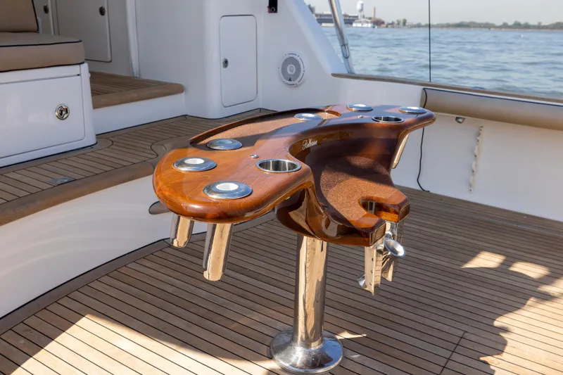  Yacht Photos Pics Luxurious 2012 Cabo 44 Hardtop Express yacht with elegant wooden deck and fishing rod holders.