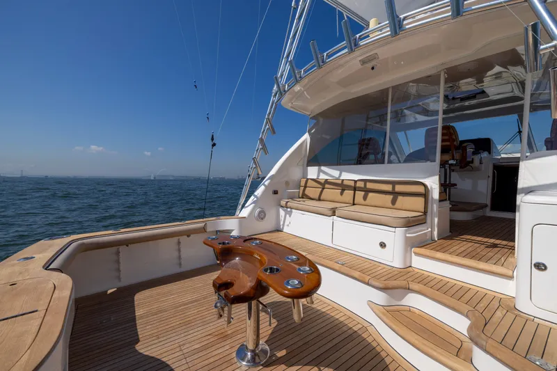  Yacht Photos Pics 2012 Cabo 44 Hardtop Express yacht with spacious deck and seating, cruising on open water.