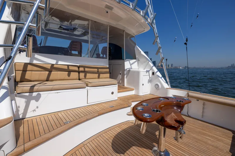  Yacht Photos Pics 2012 Cabo 44 Hardtop Express yacht with teak deck and cushioned seating.