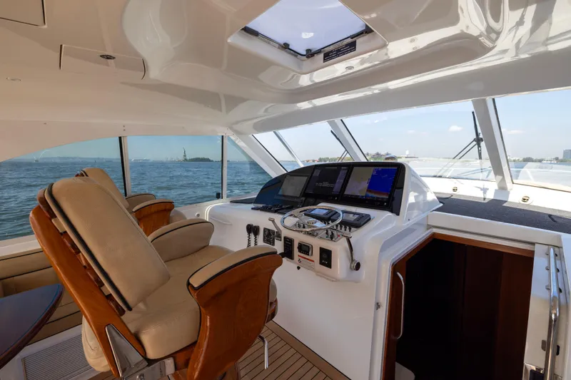  Yacht Photos Pics 2012 Cabo 44 Hardtop Express yacht helm with luxurious seating and advanced navigation system.