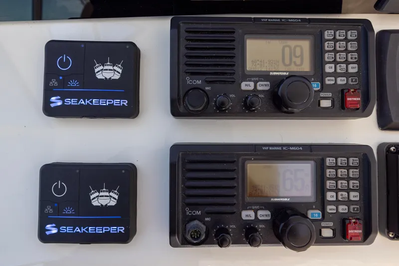  Yacht Photos Pics Seakeeper and VHF marine radio controls on 2012 Cabo 44 Hardtop Express boat.
