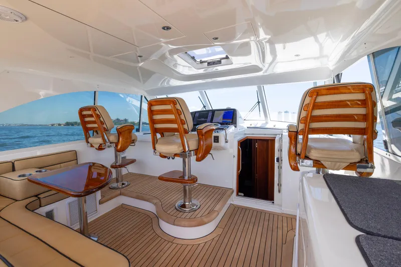  Yacht Photos Pics Luxurious interior of 2012 Cabo 44 Hardtop Express yacht with elegant seating and navigation area.