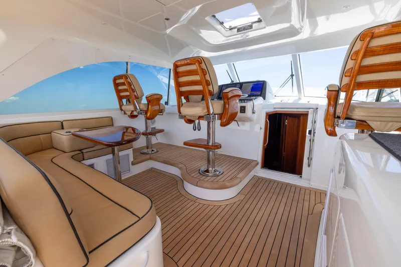  Yacht Photos Pics Luxurious interior of 2012 Cabo 44 Hardtop Express yacht with elegant seating and helm chairs.