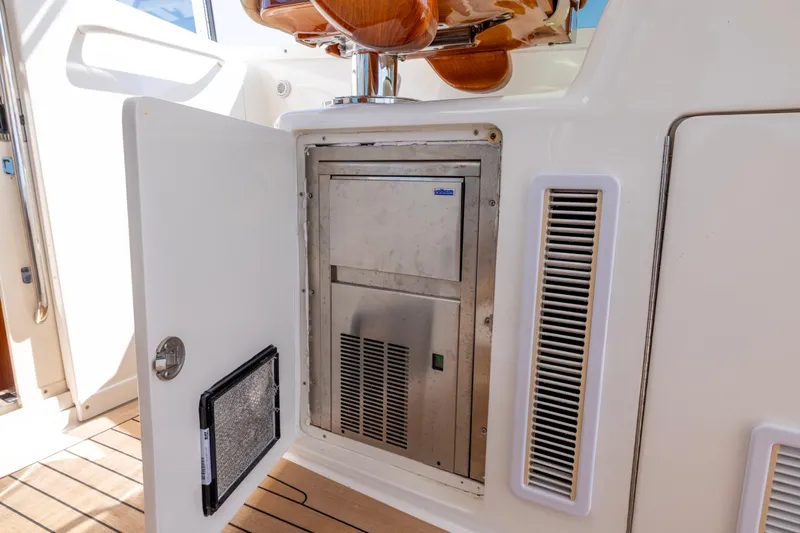  Yacht Photos Pics 2012 Cabo 44 Hardtop Express yacht with open storage compartment and stainless steel appliance.