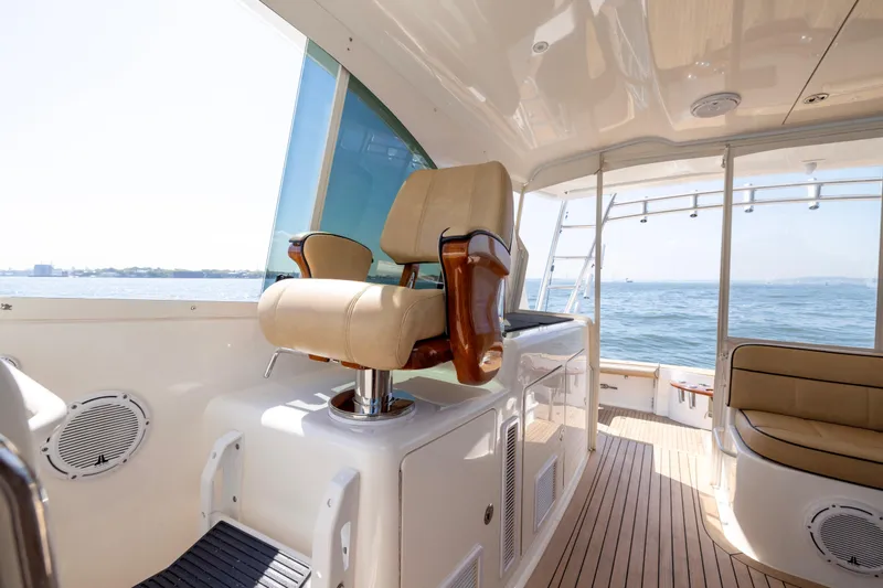  Yacht Photos Pics Luxurious 2012 Cabo 44 Hardtop Express yacht interior with ocean view and plush seating.