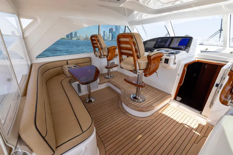  Yacht Photos Pics Luxurious interior of 2012 Cabo 44 Hardtop Express yacht with plush seating and modern helm.