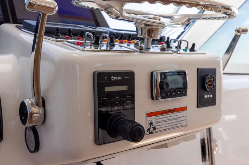  Yacht Photos Pics Control panel of 2012 Cabo 44 Hardtop Express yacht with steering wheel and navigation equipment.