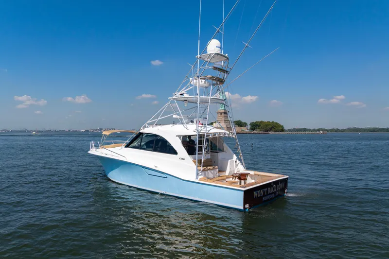  Yacht Photos Pics 2012 Cabo 44 Hardtop Express yacht cruising on a sunny day.